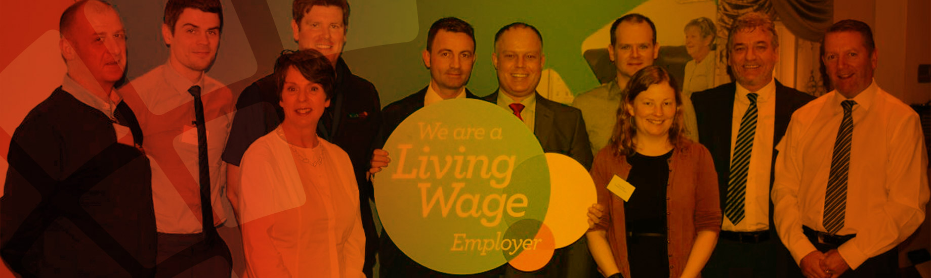 Employees stand with Living Wage sign
