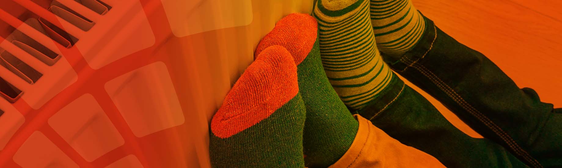 Feet in socks leaning on radiator